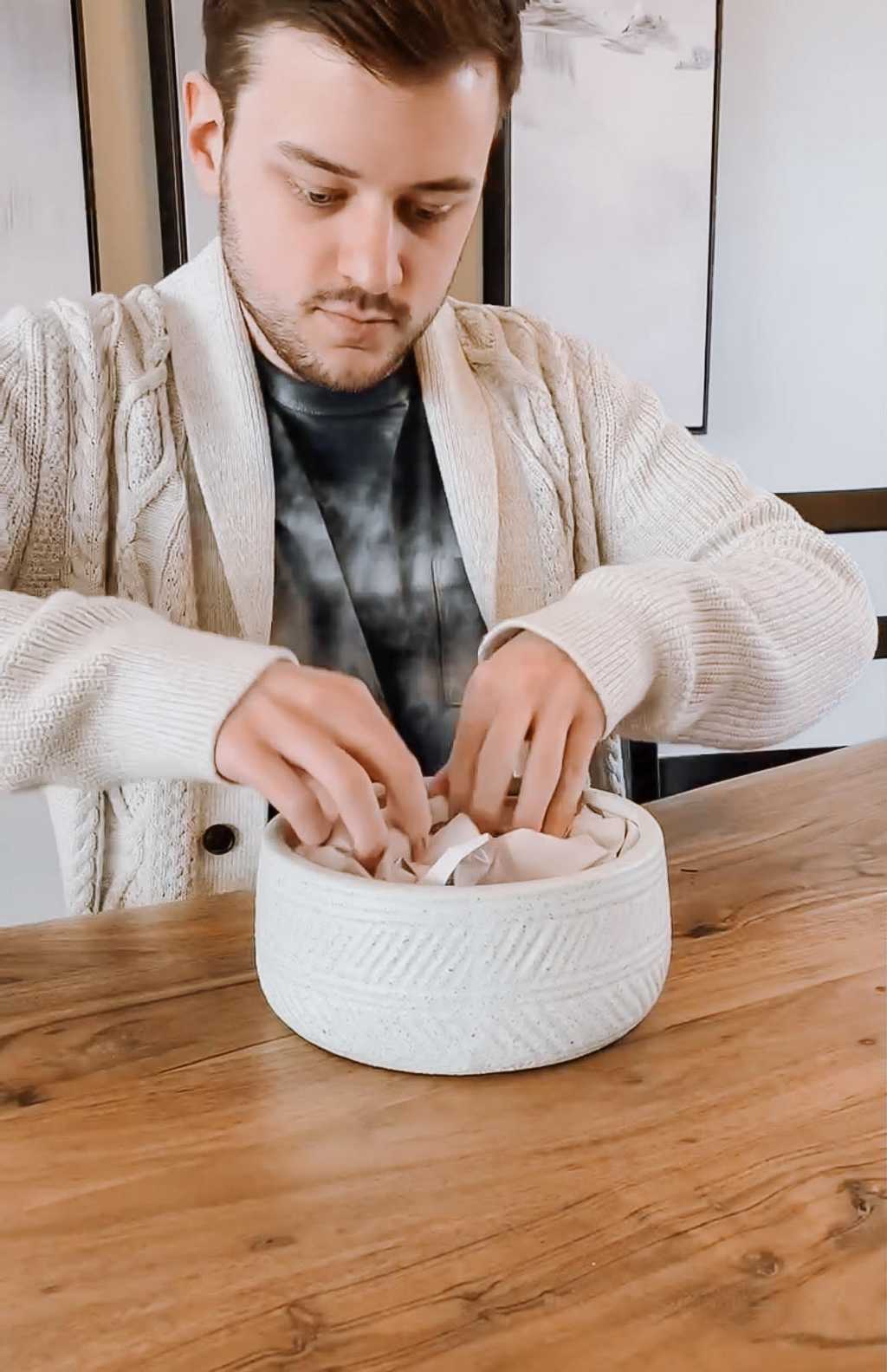 Bowl being filled with paper